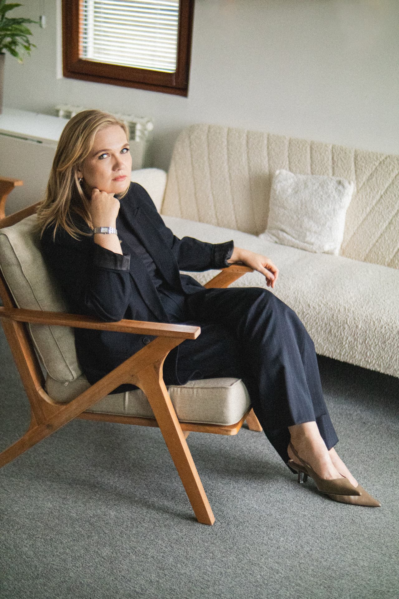 Olga Skipper seated in a wooden armchair